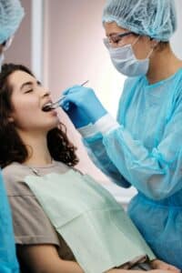 a dentist checking on a patient's wisdom teeth